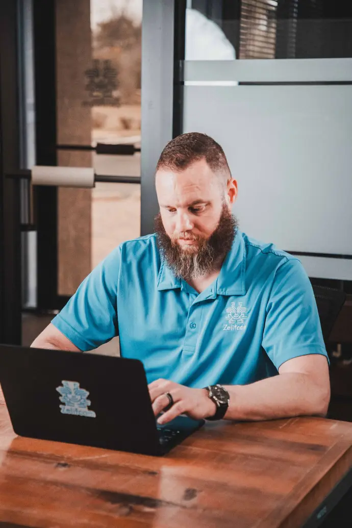 Zelifcam team member working at a laptop